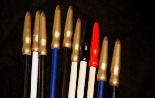 Painted wooden flag dowels with spear tips, available in bulk for high-volume manufacturing.